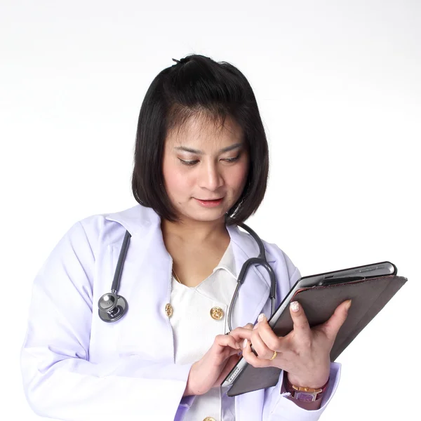 Woman doctor looking at a table — Stock Photo, Image