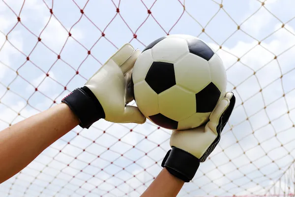 Goalkeeper's hands reaching for foot ball — Stock Photo, Image