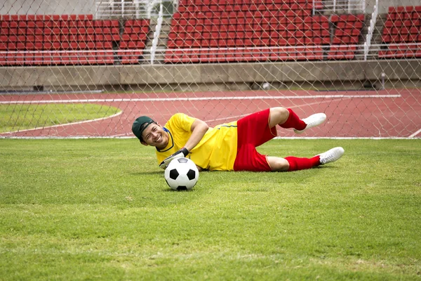 Goalkeeper catches the soccer ball — Stock Photo, Image
