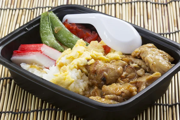 Chicken Toriyaki rice in plastic box with plastic spoon — Stock Photo, Image