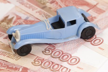Toy car on a paper money