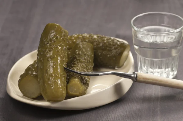 Salted cucumbers and vodka — Stock Photo, Image