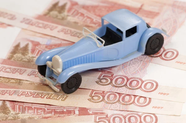 Toy car on a paper money