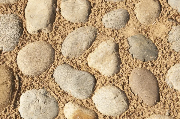 Pebbles and sand as a background — Stock Photo, Image