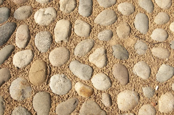 Pebbles and sand as a background — Stock Photo, Image