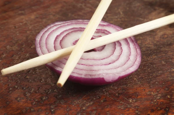 Still life with chopsticks and onion — Stock Photo, Image