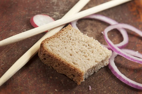 Still life with chopsticks, bread and vegetables — Stock Photo, Image