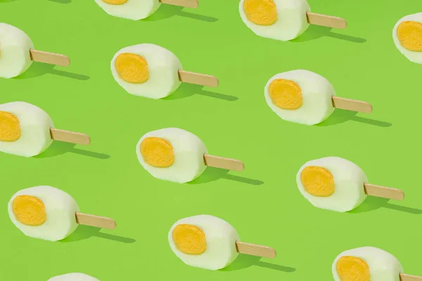 Yeşil arka planda dondurmalı yeni kesilmiş Paskalya yumurtası. Yaratıcı yemek ya da tatil konsepti.