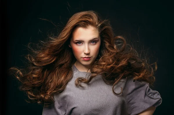 Portrait of young beautiful woman with long flowing hair