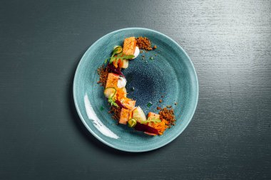 Fresh and beutiful slow cooked salmon on dark blue background, micheli star restaurant