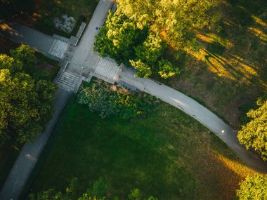 City park from above, summer evening at city park, Pedestrian paths and crosswalks in city park. Green area in the city