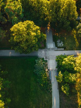City park from above, summer evening at city park, Pedestrian paths and crosswalks in city park. Green area in the city