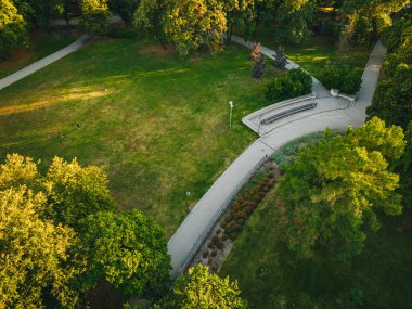 City park from above, summer evening at city park, Pedestrian paths and crosswalks in city park. Green area in the city