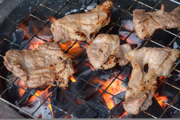 Pork steak on the grill with flames — Stock Photo, Image