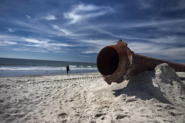 Rusty pipes along the sea beach — Stock Photo, Image