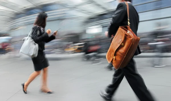 Motion blurred business people walking on the street — Stock Photo, Image