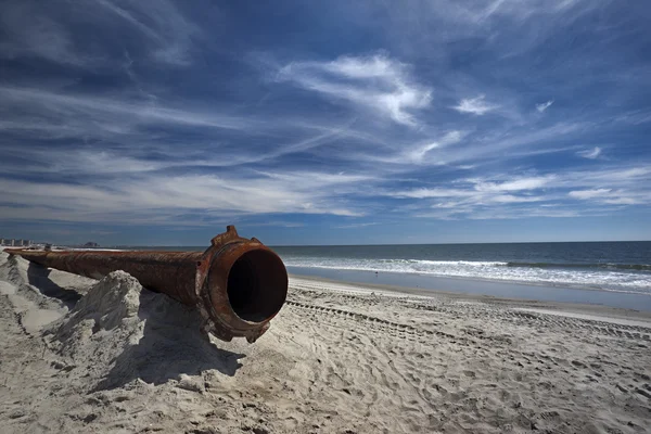 Rusty pipes along the sea beach — Stock Photo, Image