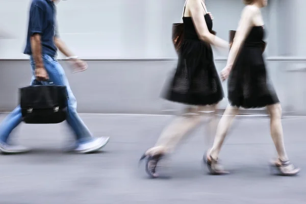 Motion blurred business people walking on the street — Stock Photo, Image