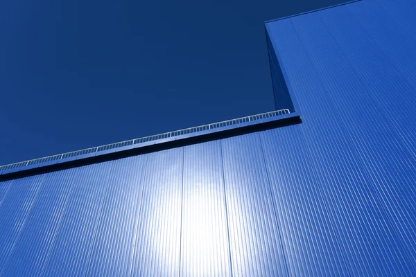 Blue wall of a building with fence — Stock Photo, Image
