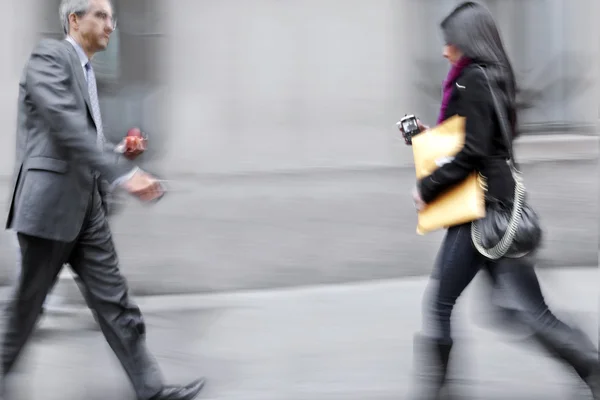 Motion blurred business people walking on the street — Stock Photo, Image