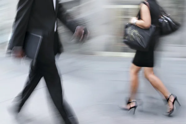 Motion blurred business people walking on the street — Stock Photo, Image