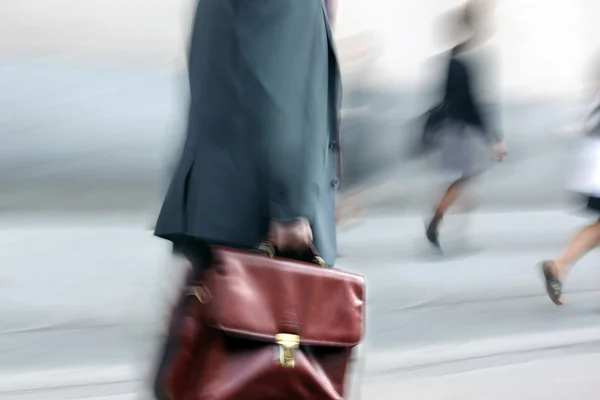 Motion blurred business people walking on the street — Stock Photo, Image