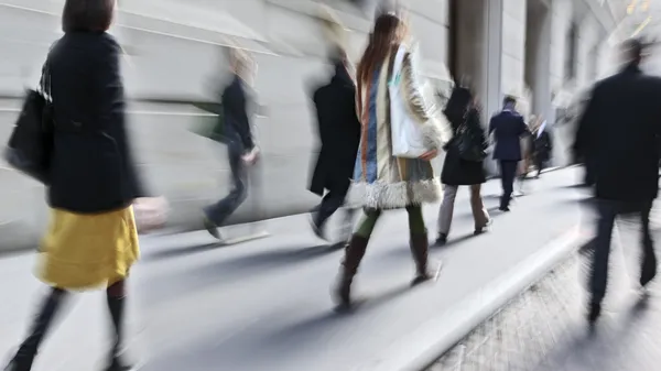 Motion blurred business people walking on the street — Stock Photo, Image