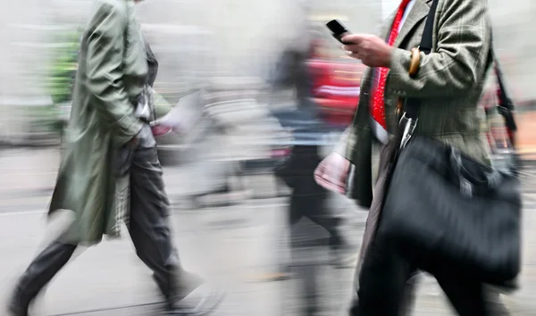 Motion blurred business people walking on the street — Stock Photo, Image