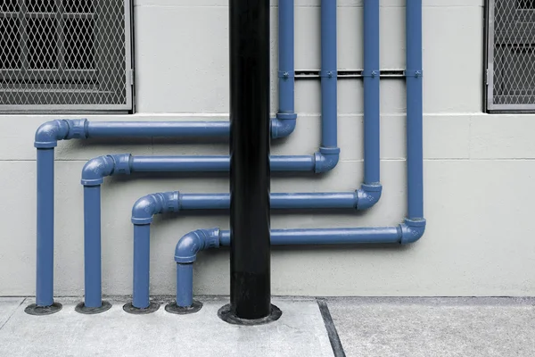 Colorful of pipes under the modern building — Stock Photo, Image