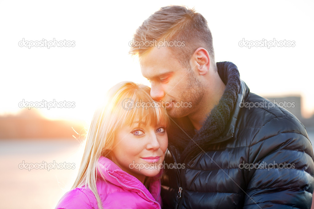 Young man embraces his girlfriend