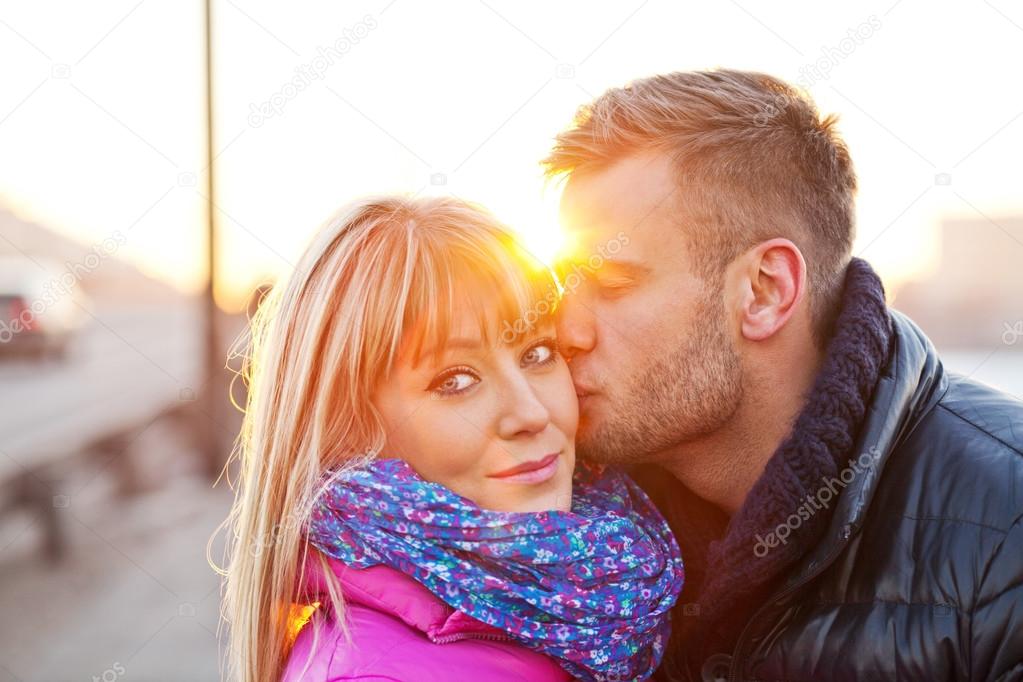 Young man kissing a beautiful woman