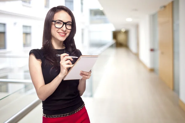 Chica en la oficina con bloc de notas de papel — Foto de Stock