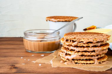 Geleneksel Hollanda usulü otantik Hollanda tatlı ev yapımı lezzetli kahverengi waffle erimiş tuzlu karamelli bal pekmezi ve Stroopwafel adında sıcak kahve sütlü çay.
