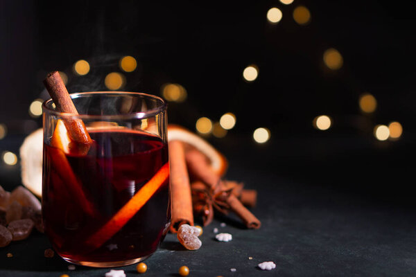 Gluhwein sweet hot warm Mulled red Wine or punch tea in mug cup glass spices citrus aromatic cinnamon star anise German tradition winter Christmas market beverage drink new year holidays festival