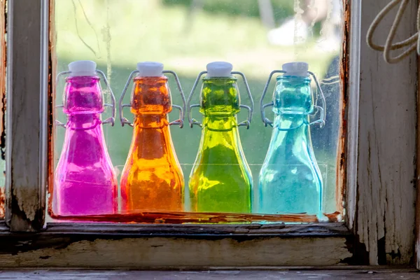 Colored Vintage Bottles on Window Sill — Stock Photo, Image