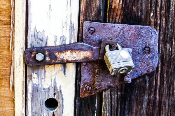 Weathered wooden door with lock — Stock Photo, Image