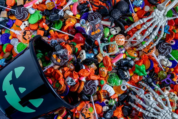 Skeleton Hands Grabbing Variety Halloween Candy Spilling Out Black Candy — Stock Photo, Image