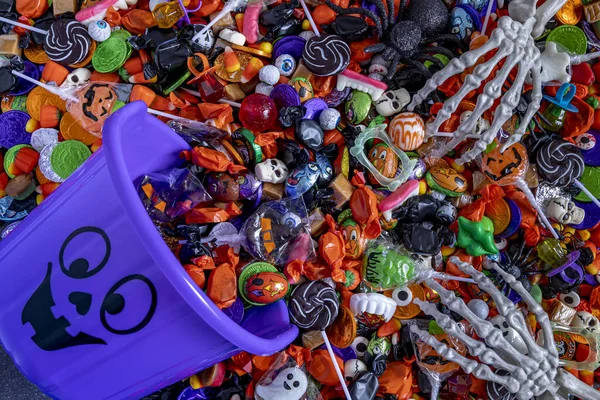 Skeleton Hands Grabbing Variety Halloween Candy Spilling Out Light Purple — Stock Photo, Image