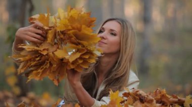 güzel sarışın Park düşen yapraklar üzerinde yalan