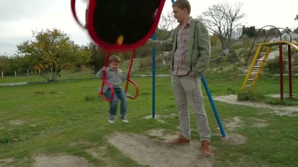 Father with little son having fun in the playground — Stock Video