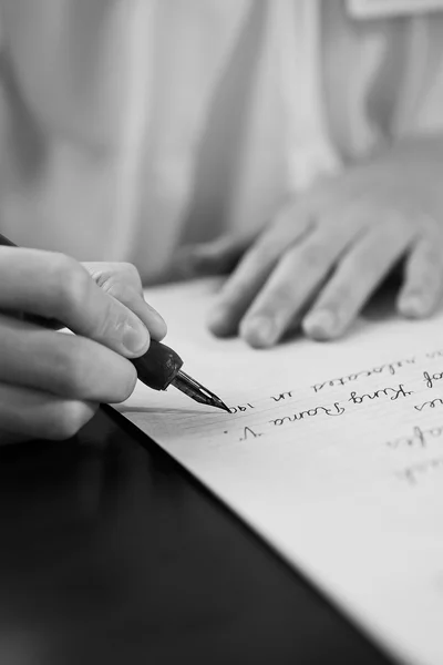 Retro effect faded and toned image of a girl writing a note with a fountain pen antique handwritten letter. — Stock Photo, Image