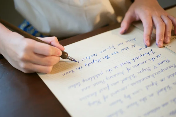 Retro effect faded and toned image of a girl writing a note with a fountain pen antique handwritten letter. — Stock Photo, Image