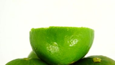 Yeşil limonun 4K dönüşü. Üst manzara, 360 derece döndürme, limonu kesme..