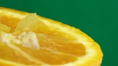 Göbek portakal meyvesinin 4K Macro görüntüsü. Turuncu turunçgil yeşili arka plan 4K UHD video.