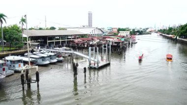 4K view Tourists on the long tail boat and boatman at Bangkok Noi Canal hat use boat trip community lifestyle  cultural tourism