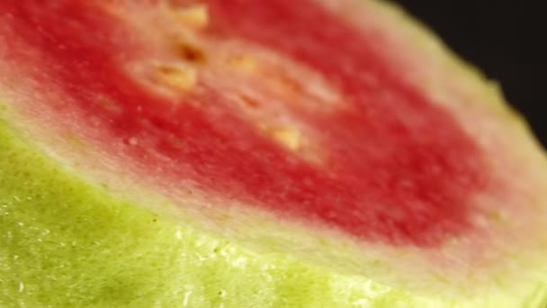 Macro Close Organic Sliced Guava Rotating Plate Isolated Black Background — стоковое видео