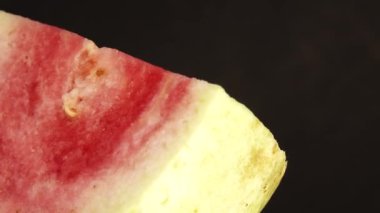 4K macro close up organic sliced guava rotating plate isolated on black background