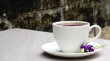 4K ultra hd tea in white cup laid on granite floor old wall food and drink.    