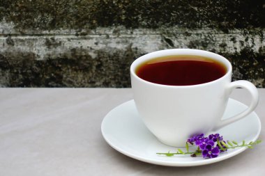Tea in white cup laid on granite floor old wall food and drink. 