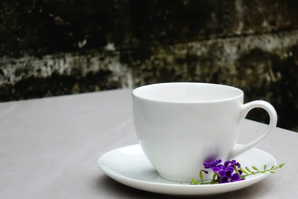 Tea in white cup laid on granite floor old wall food and drink.